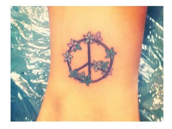 Signe de paix avec tatouage de fleurs