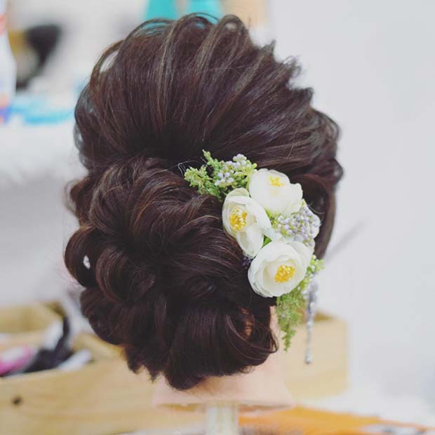 Chignon bas élégant avec accessoire floral