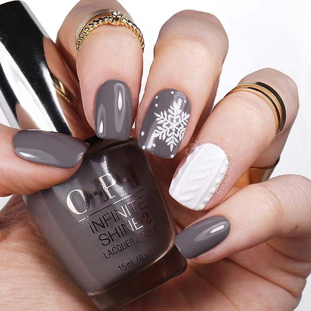 Ongles de flocon de neige gris avec un ongle d'accent tricoté blanc