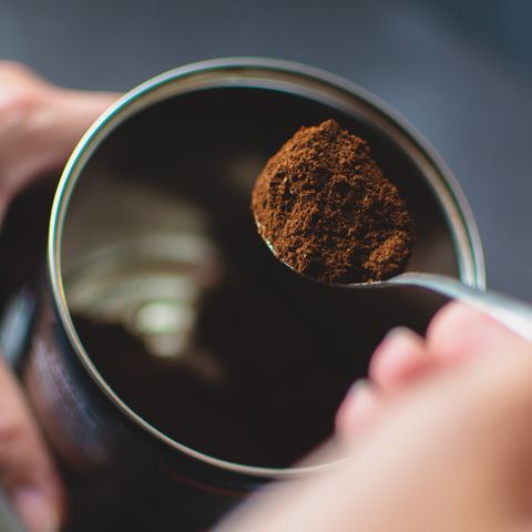 main recadrée faisant du café à table répulsif contre les fourmis