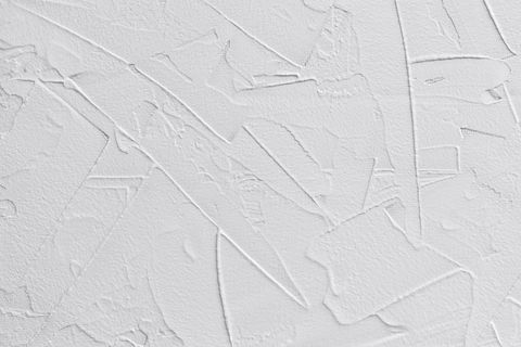 fond abstrait blanc de pâte de remplissage et de plâtre de liaison avec des tirets et des traits irréguliers