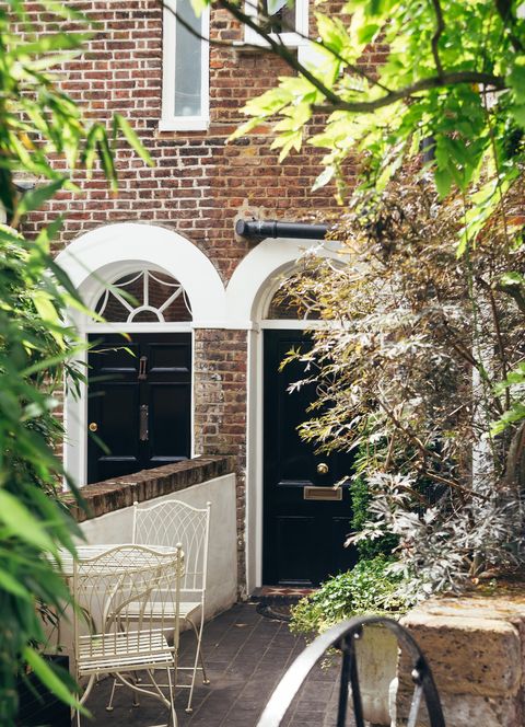 לונדון, בריטניה 17 ביולי 2019 דלת הכניסה השחורה של בית מרפסת אנגלית מסורתית בית מרפסת הוא סוג של דיור בצפיפות בינונית שמקורו באירופה במאה ה -16.